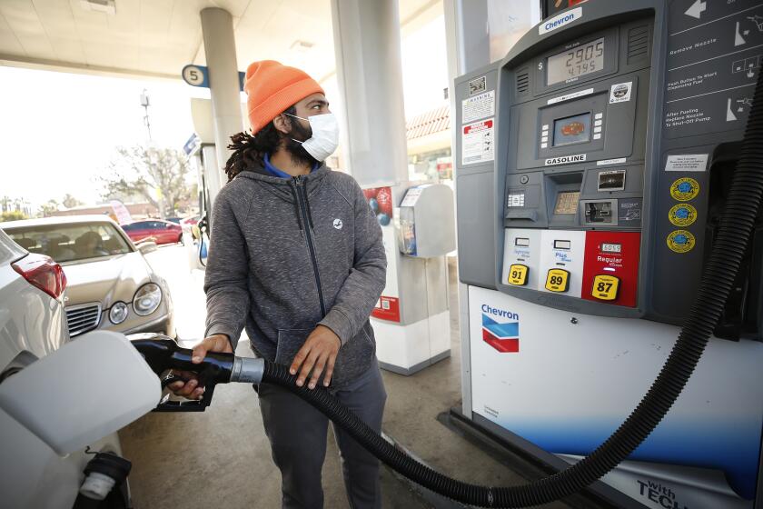 LOS ANGELES, CA - NOVEMBER 15: Damian Maculam, 29, watches the total increase as drivers select from various fuels all priced over $6 dollars at a Chevron Gas Station located at North Alameda and West Cesar Chavez Ave near Union Station in downtown Los Angeles as California gas prices hit an average price of $4.676 Sunday, setting the highest recorded average price for regular gasoline, according to AAA. America's largest state by population has the highest gas prices in the country. The national average dropped slightly to $3.413 Sunday. Downtown on Monday, Nov. 15, 2021 in Los Angeles, CA. (Al Seib / Los Angeles Times).