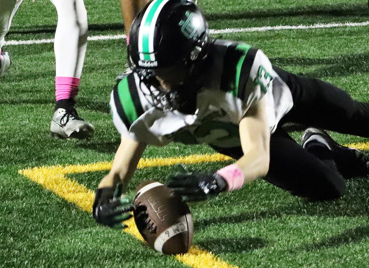 Costa Mesa's Rex Tompkins (13) dives on a loose ball in the end zone for a touchdown against Bolsa Grande on Thursday.