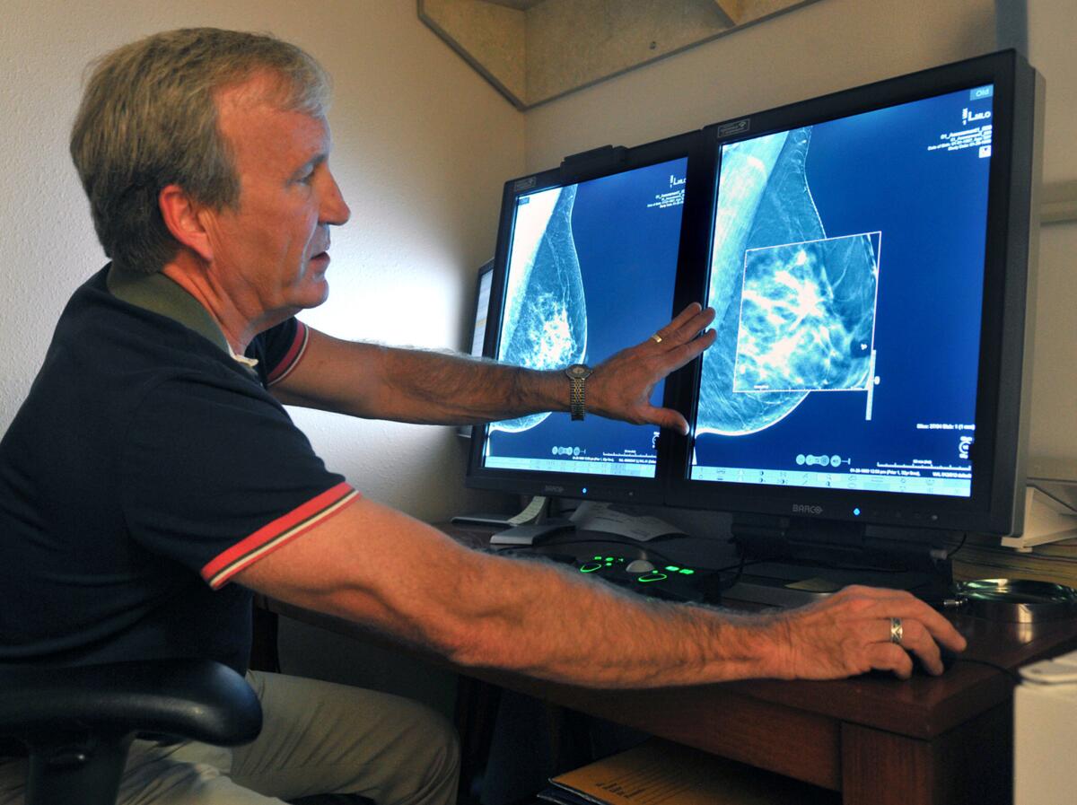 A radiologist compares an image from an earlier, two-dimensional technology mammogram to the new 3D mammography. The technology can detect much smaller cancers earlier.
