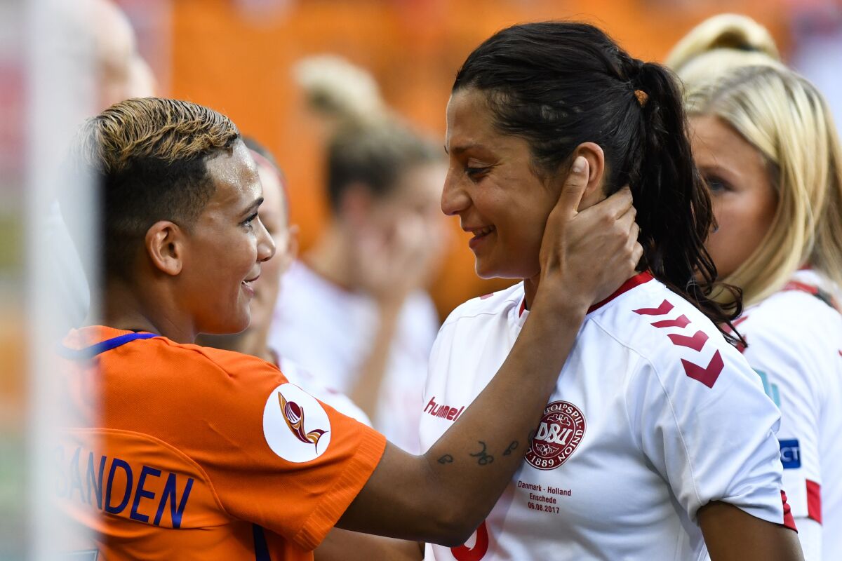 Shanice van de Sanden of the Netherlands, left, embraces Denmark's Nadia Nadim.