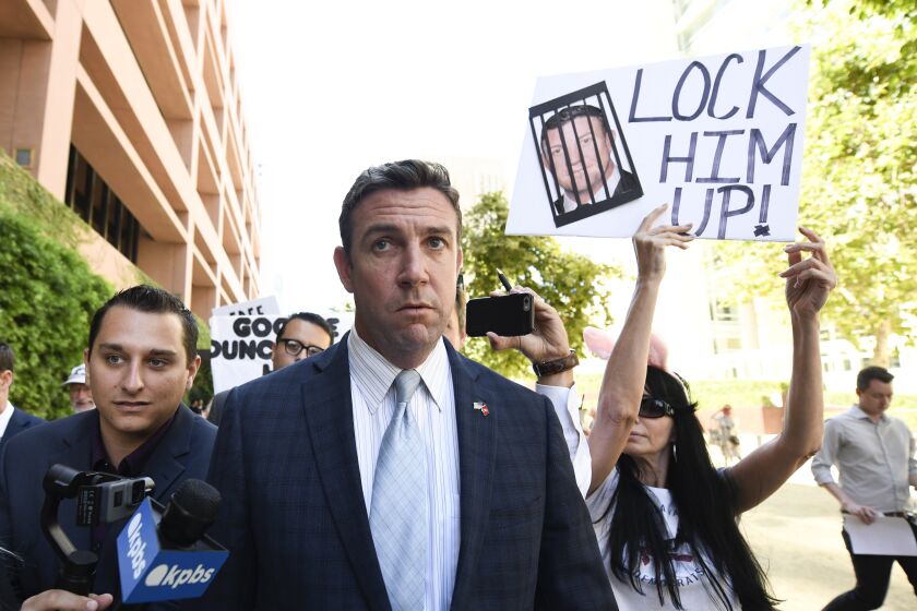 CORRECTS TO ATTRIBUTE THE REFERENCE TO HUNTER, NOT A JUSGE - FILE - In this July 1, 2019, file photo, U.S. Rep. Duncan Hunter leaves federal court after a motions hearing in San Diego. The California Republican plans to plead guilty on Tuesday, Dec. 3, 2019, to the misuse of campaign funds and has indicated he will leave Congress, he told KUSI television in San Diego in an interview that aired Monday. (AP Photo/Denis Poroy, File)