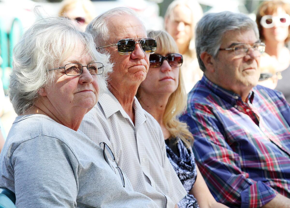 Barbara Melone's sister Kathleen Johnson, husband John Melone, daughter Carol Melone, and family friend Jim Adam at a bench dedication in honor of Barbara Melone at Clark Magnet High School in Glendale on Wednesday, April 30, 2014. Melone a senior administrative secretary at the school, died at the beginning of the school year, and the bench was placed in her honor.