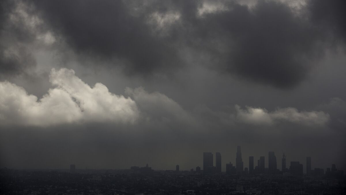 Low clouds drift over the Los Angeles Basin and downtown as light rain and cooler temperatures prevail on Oct. 18.