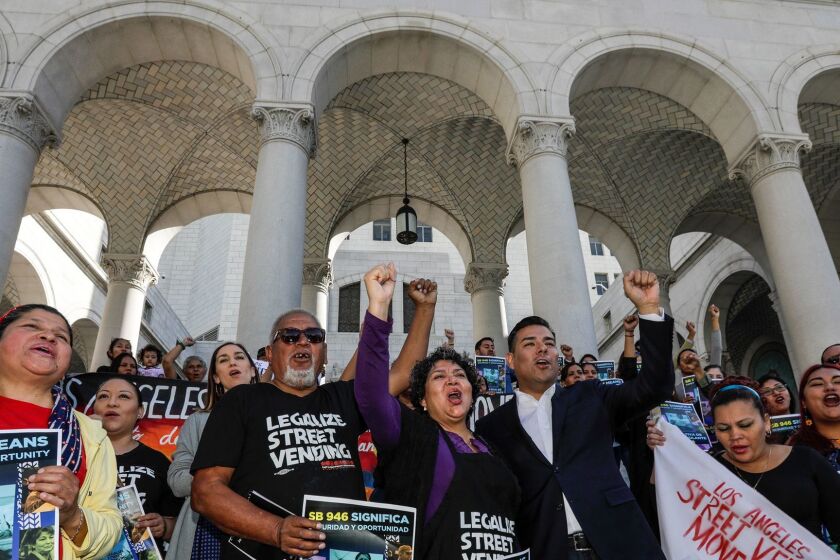 LOS ANGELES CA FEBRUARY 02, 2018 --- Sidewalk vendors and members of the Los Angeles Vendor Campaign rally in support of a bill, Safe Sidewalk Vending Act, Senate Bill 946, that would protect vendors from harassment, arrest or deportation. Senator Ricardo Lara, fourth from left in front row, and several sidewalk vendors spoke at the rally held on February 02, 2018 on the steps of Los Angeles City Hall. (Irfan Khan / Los Angeles Times)