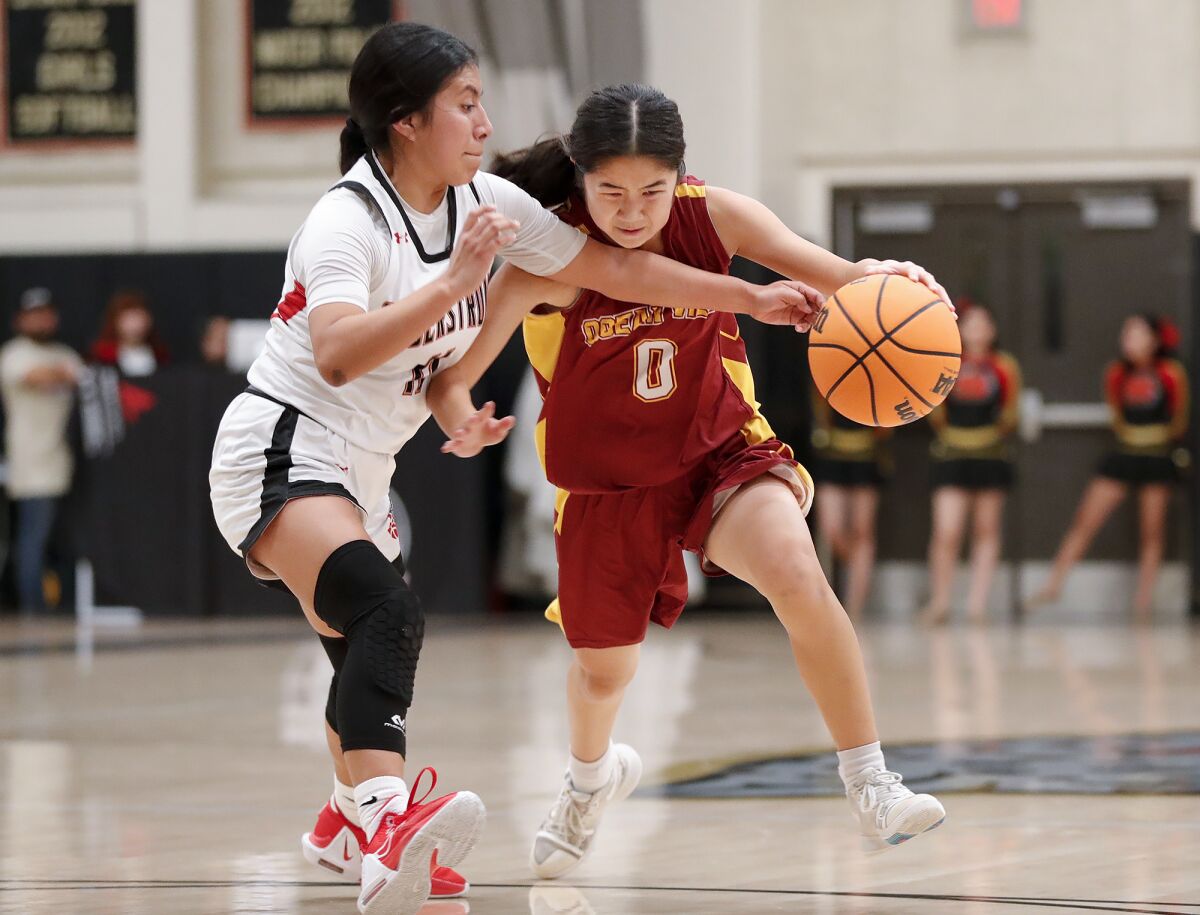 Ocean View's Laney Bae (0) drives around Segerstrom's Valeria Quero during a Golden West League game on Wednesday.