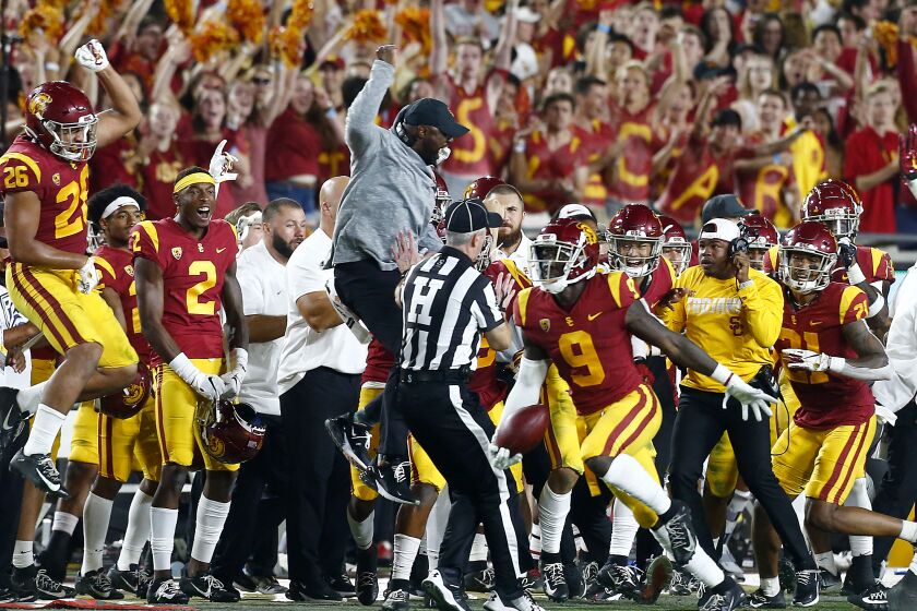 LOS ANGELES, CALIF. - SEP. 7, 2019. USC defensive back Greg Johnson (9) and the Trojans bench celebrate Johnson's interception of a pass by Stanford quarterback Davis Mills in the fourth quarter at the L.A. Memorial Coliseum on Saturday night, Sep. 7, 2019. (Luis Sinco/Los Angeles Times)