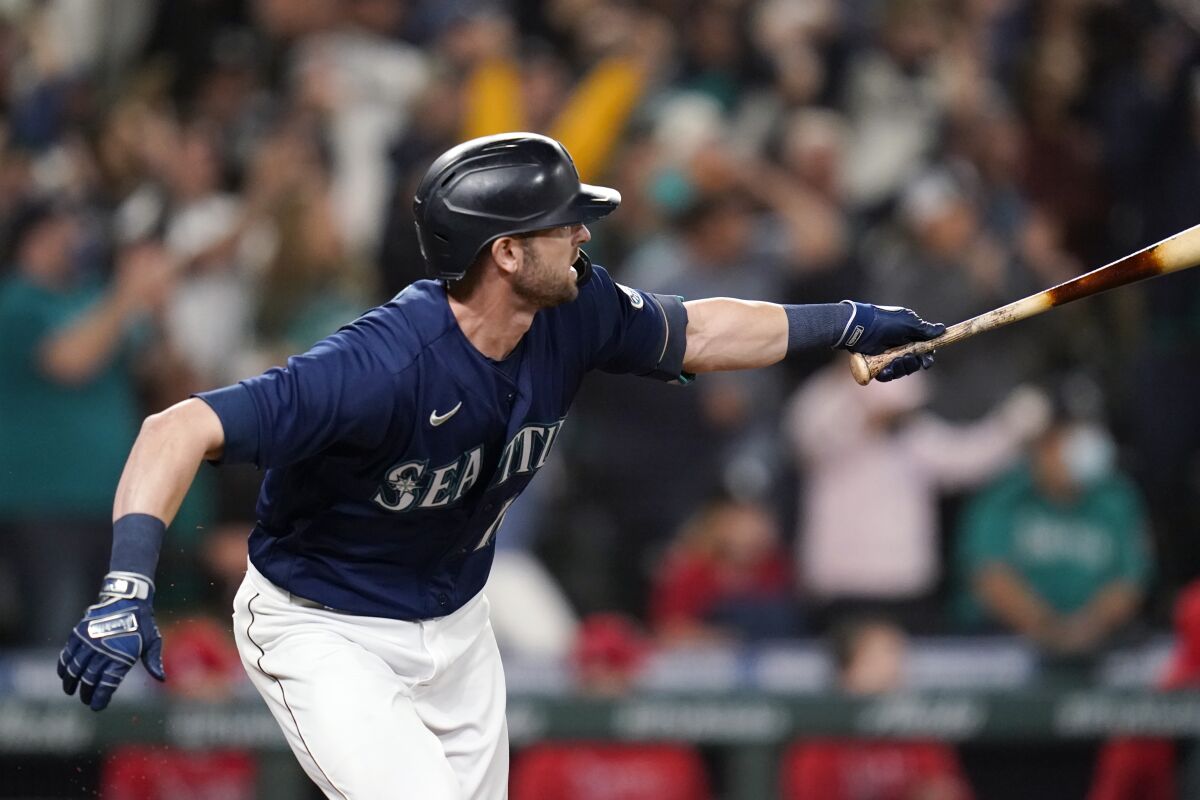 Seattle Mariners' Mitch Haniger singles in a pair of runs against the Los Angeles Angels in the eighth inning of a baseball game Saturday, Oct. 2, 2021, in Seattle. (AP Photo/Elaine Thompson)