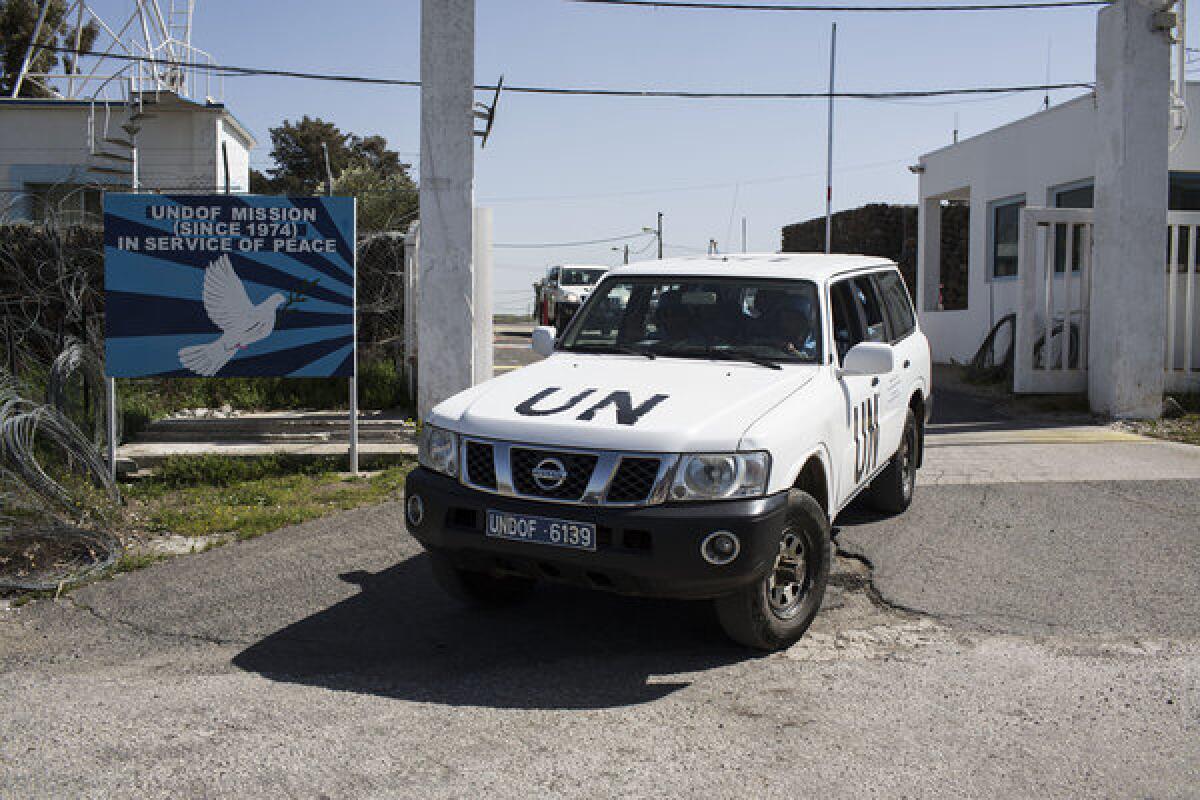 U.N. military drive a vehicle in the Golan Heights region along Israel's border with Syria.