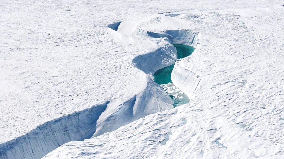 Meltwater floods a canyon on the Greenland ice sheet. Geoengineering has the potential to prevent massive melting even if greenhouse gas emissions continue to rise.