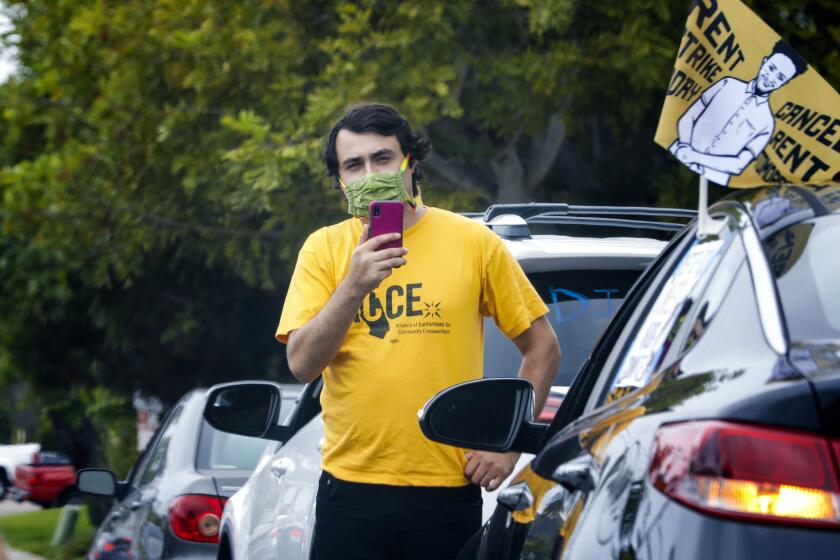 Jose Lopez an organizer with ACCE (Alliance of Californians for Community Empowerment) used his phone to video the caravan of cars taking part in their protest in La Jolla on Wednesday, July 1, 2020. The protestors drove in caravan past the La Jolla homes of Pradeep K. Khosla, (Chancellor UC San Diego), Michael Contreras and Doug Manchester.
