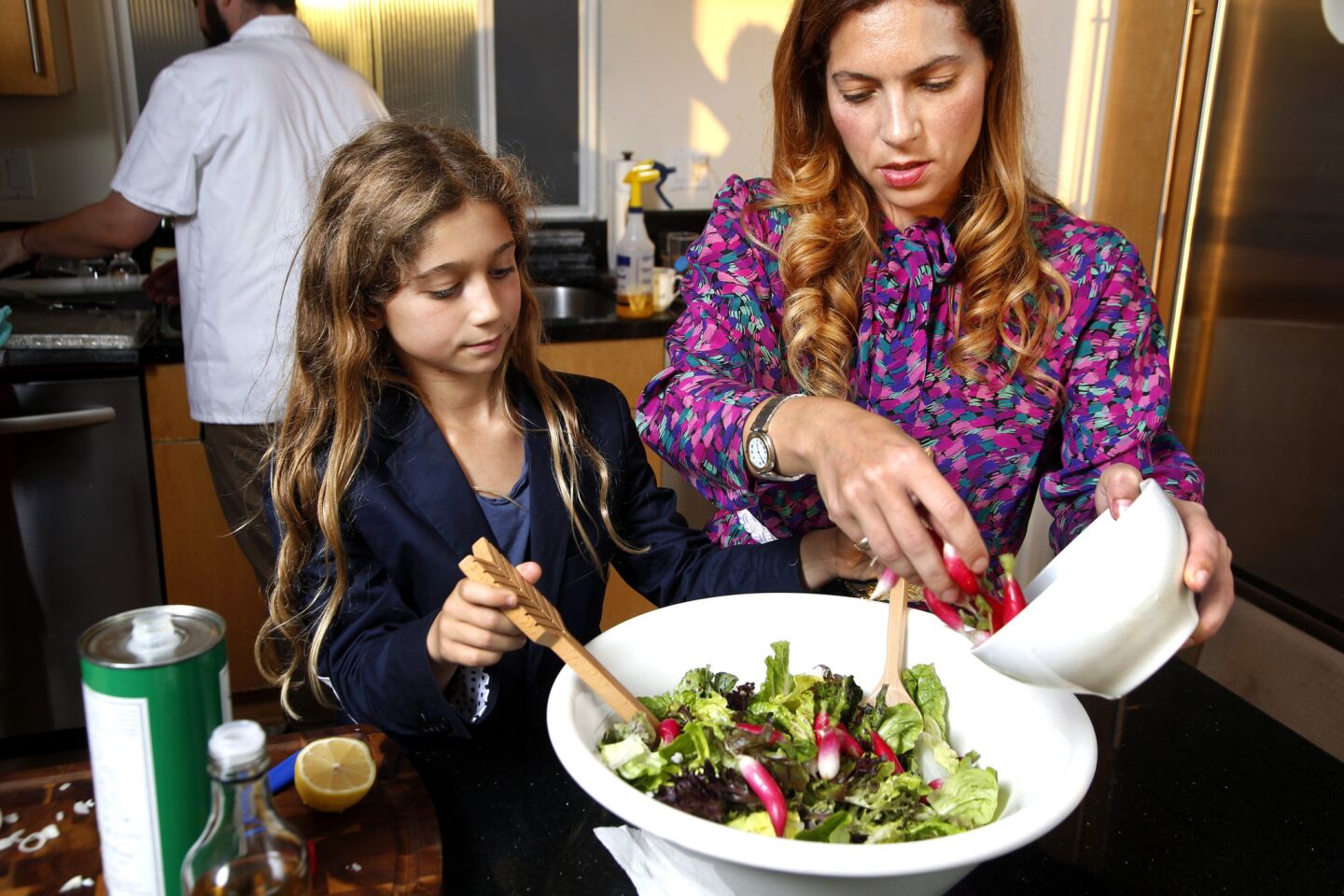 Fleur Perry Lang and daughter Noa prepare a French salad.