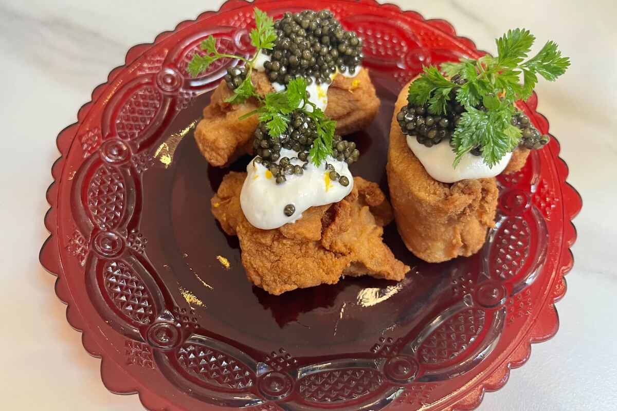  fried chicken topped with royal ossetra caviar and a dollop of labneh