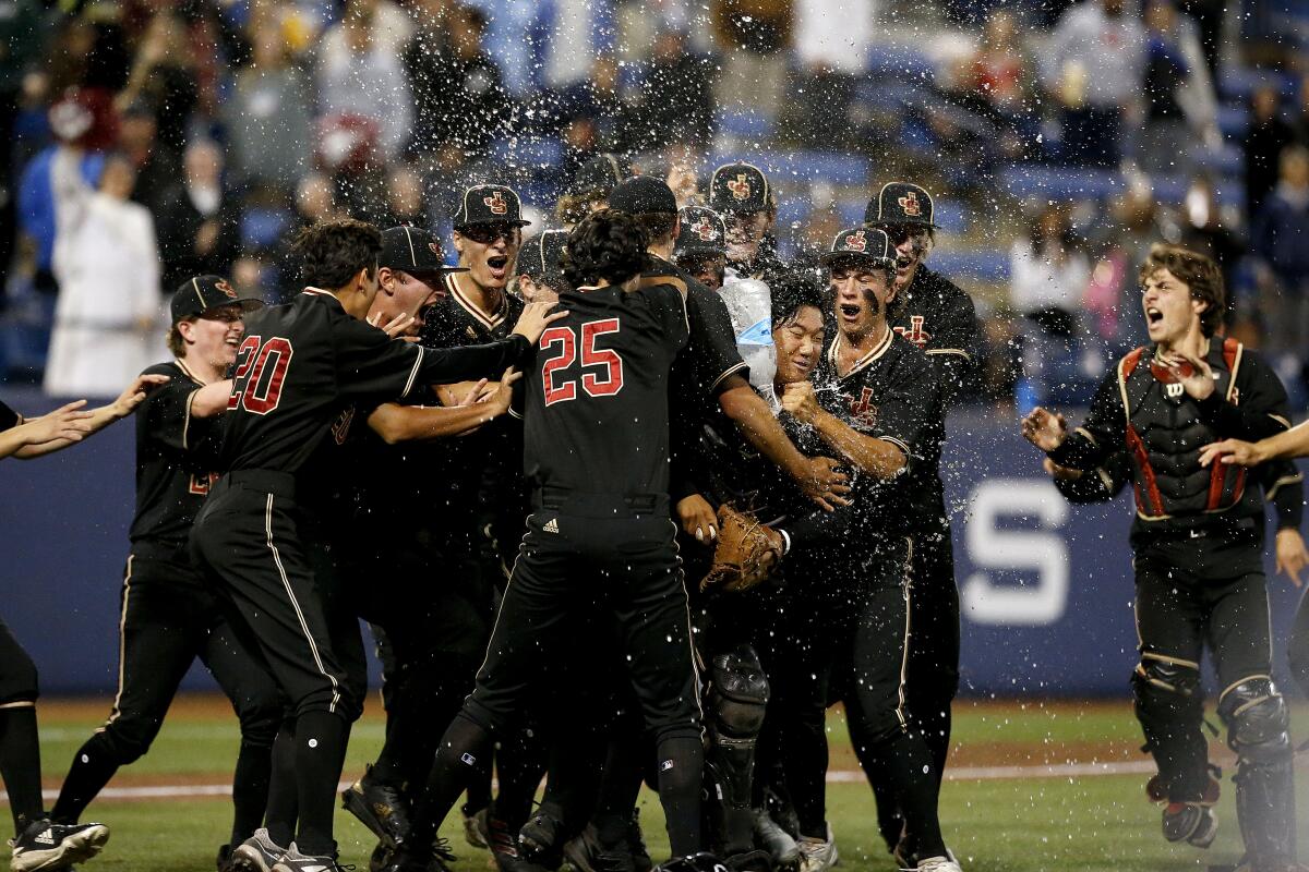 FULLERTON, CA - MAY 20: JSerra Catholic teammates rush the mound.