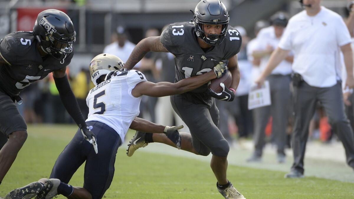 Central Florida wide receiver Gabriel Davis runs after catching a pass in front of Navy defensive back Michael McMorris during the first half on Saturday.