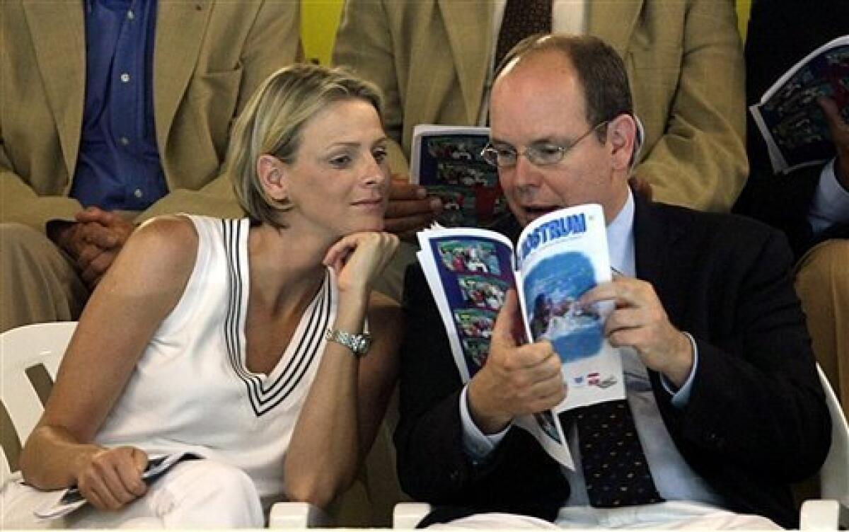 FILE - In this Sunday, June 14, 2009 file photo Prince Albert II of Monaco, right, talks with his friend Charlene Wittstock at the Mare Nostrum XXVII th International Swimming Meeting, in Monaco. The royal palace says Prince Albert of Monaco is engaged to South African former swimmer Charlene Wittstock. The principality says in a statement that the engagement was announced between the 52-year-old prince and 32-year-old Wittstock, Wednesday June 23, 2010. (AP Photo/Claude Paris, File)