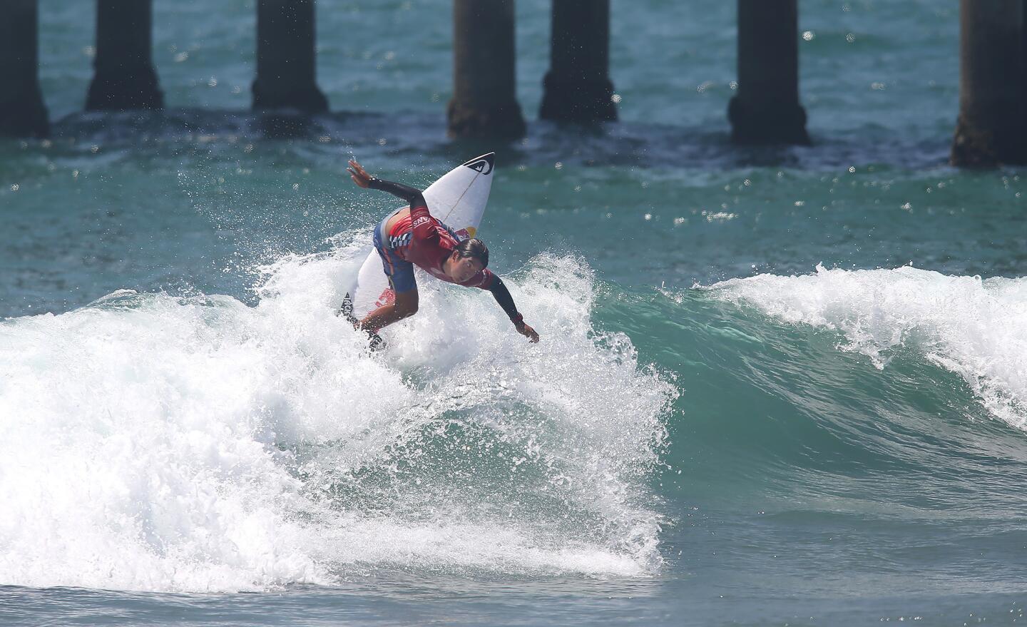 Huntington Beach local and defending champ Kanoa Igarashi goes backside off the top of a wave in route to his Men's round two heat win during the US Open of Surfing on Wednesday.
