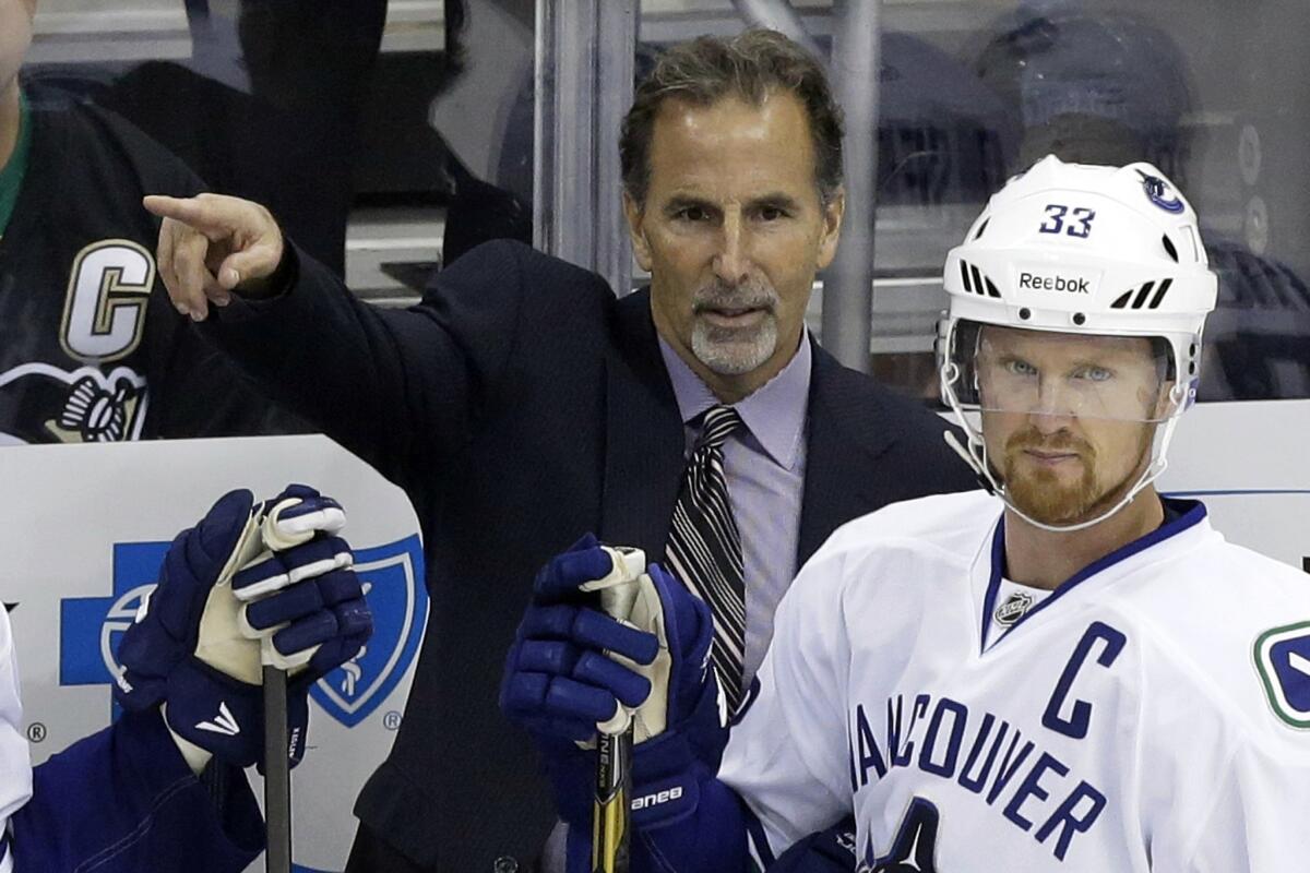 Vancouver Canucks Coach John Tortorella directs his players while standing next to team captain Henrik Sedin during a loss to the Pittsburgh Penguins on Oct. 19. Tortorella no longer embraces the often confrontational personality that was a hallmark of his days behind the New York Rangers' bench.