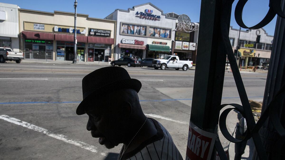 Carl Green, 59, of Lynwood, waits for a bus at Pacific and Clarendon avenues in Huntington Park.