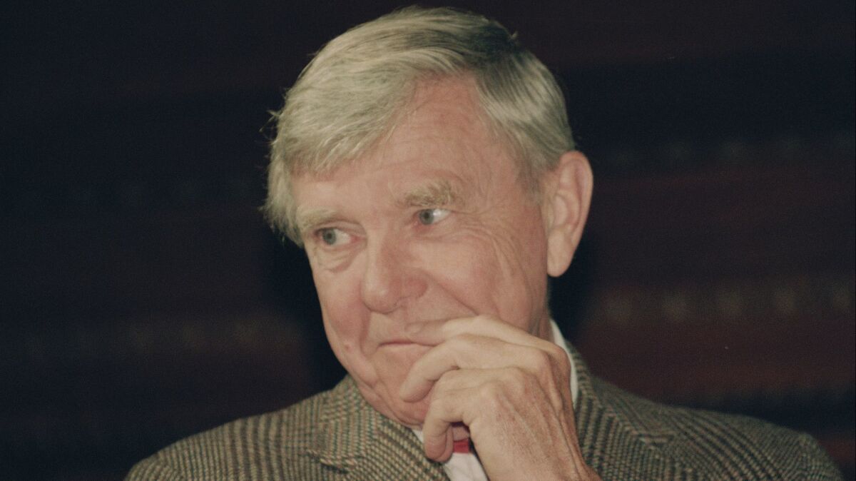Russell Baker ponders a reporter's question during a New York news conference where he was presented as the successor to host Alistair Cooke for the PBS series "Masterpiece Theatre," on Feb. 23, 1993.