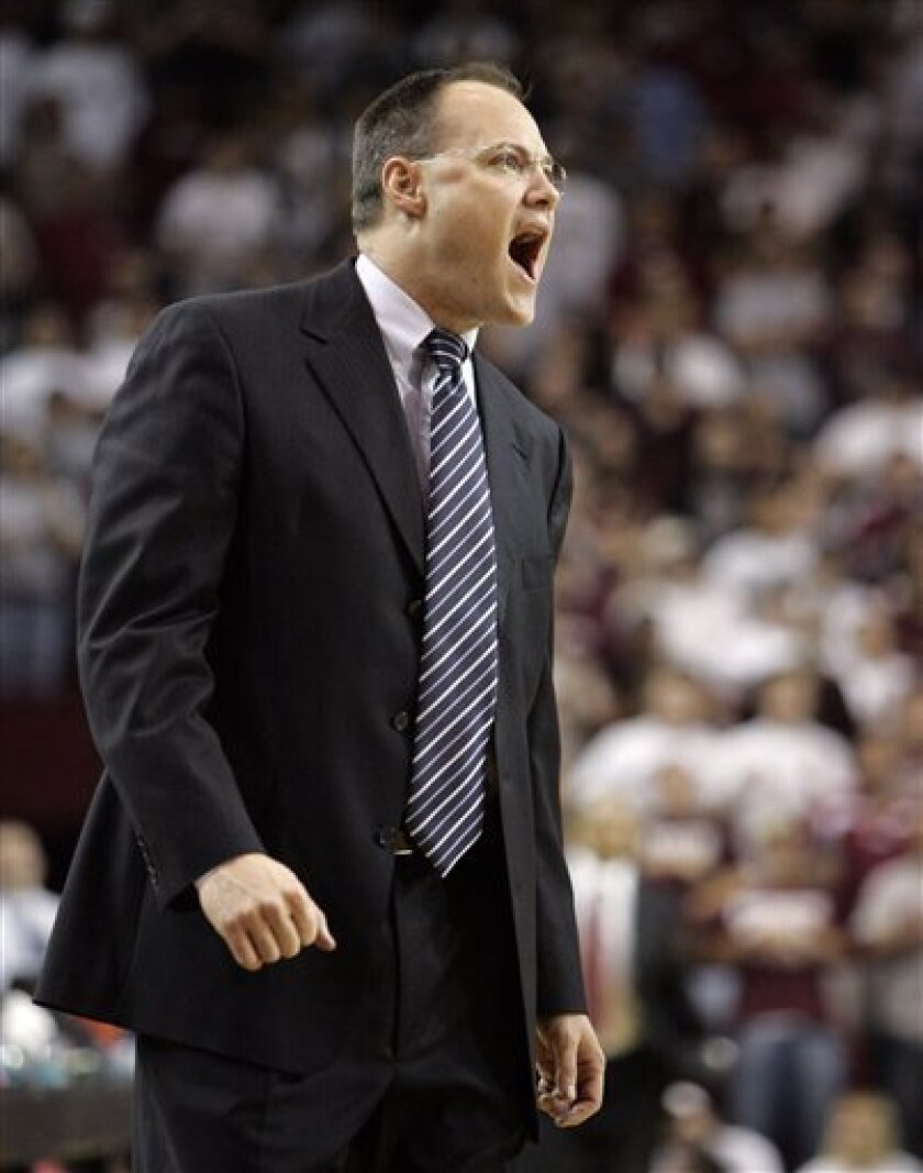 In this March 14, 2008, file photo, Nevada head coach Mark Fox yells to his team during the first half of the Western Athletic Conference basketball tournament semifinal against New Mexico State in Las Cruces, N.M. Georgia has hired Nevada's Mark Fox to replace Dennis Felton. (AP Photo/Matt York, File)