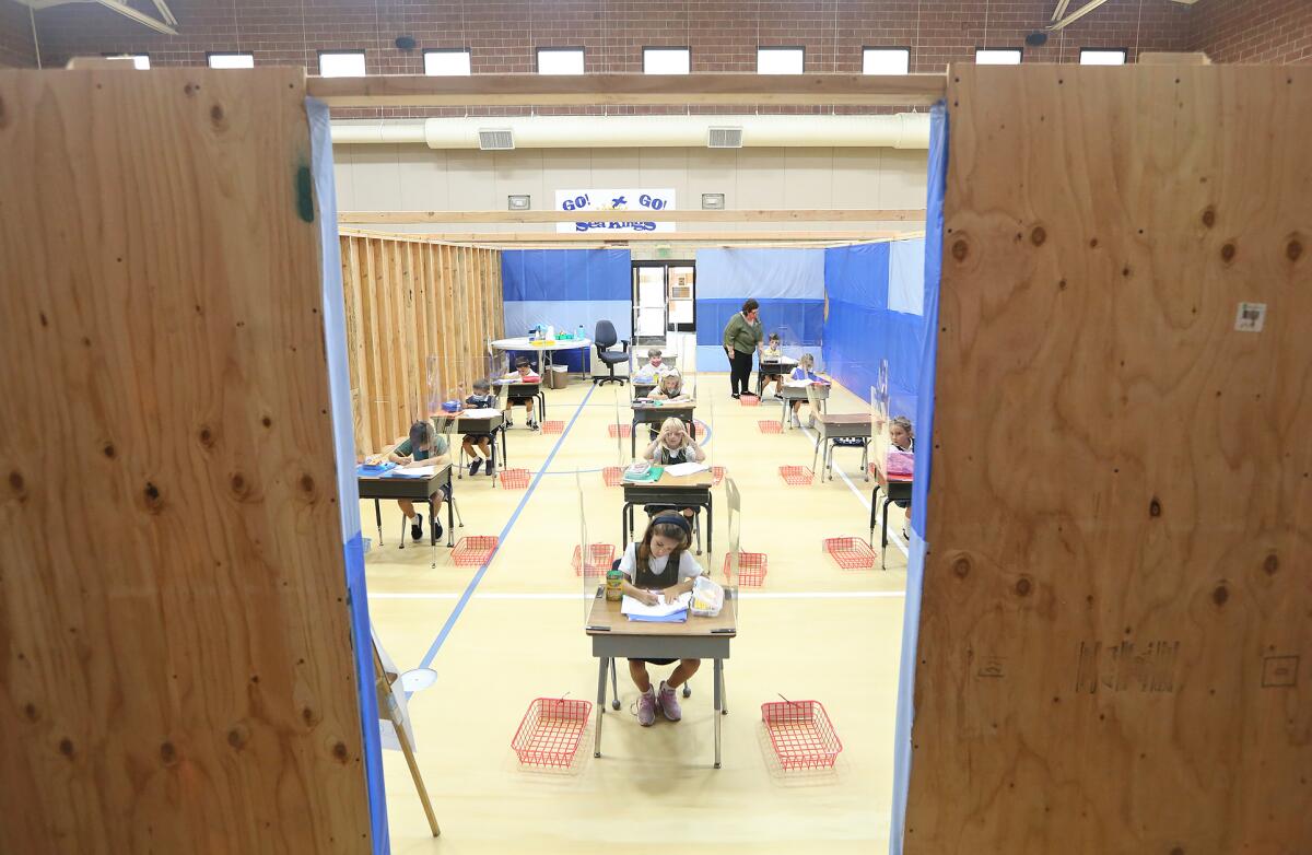 Students work inside a makeshift classroom  at St. Joachim Catholic School in Costa Mesa. 