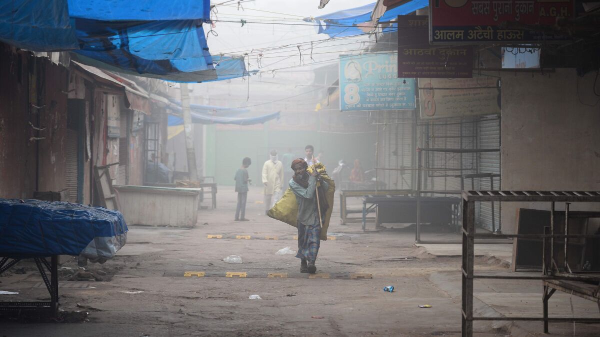 An Indian rag-picker walks amid heavy smog in New Delhi.