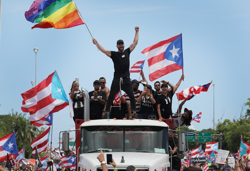 People celebrate in Puerto Rico's capital, San Juan, on Thursday, the day after Gov. Ricardo Rossello announced his resignation.