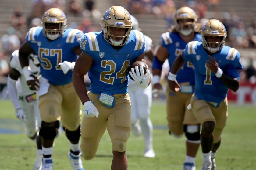 UCLA running back Zach Charbonnet breaks free for a touchdown run against Hawaii in the first quarter Aug. 28, 2021.