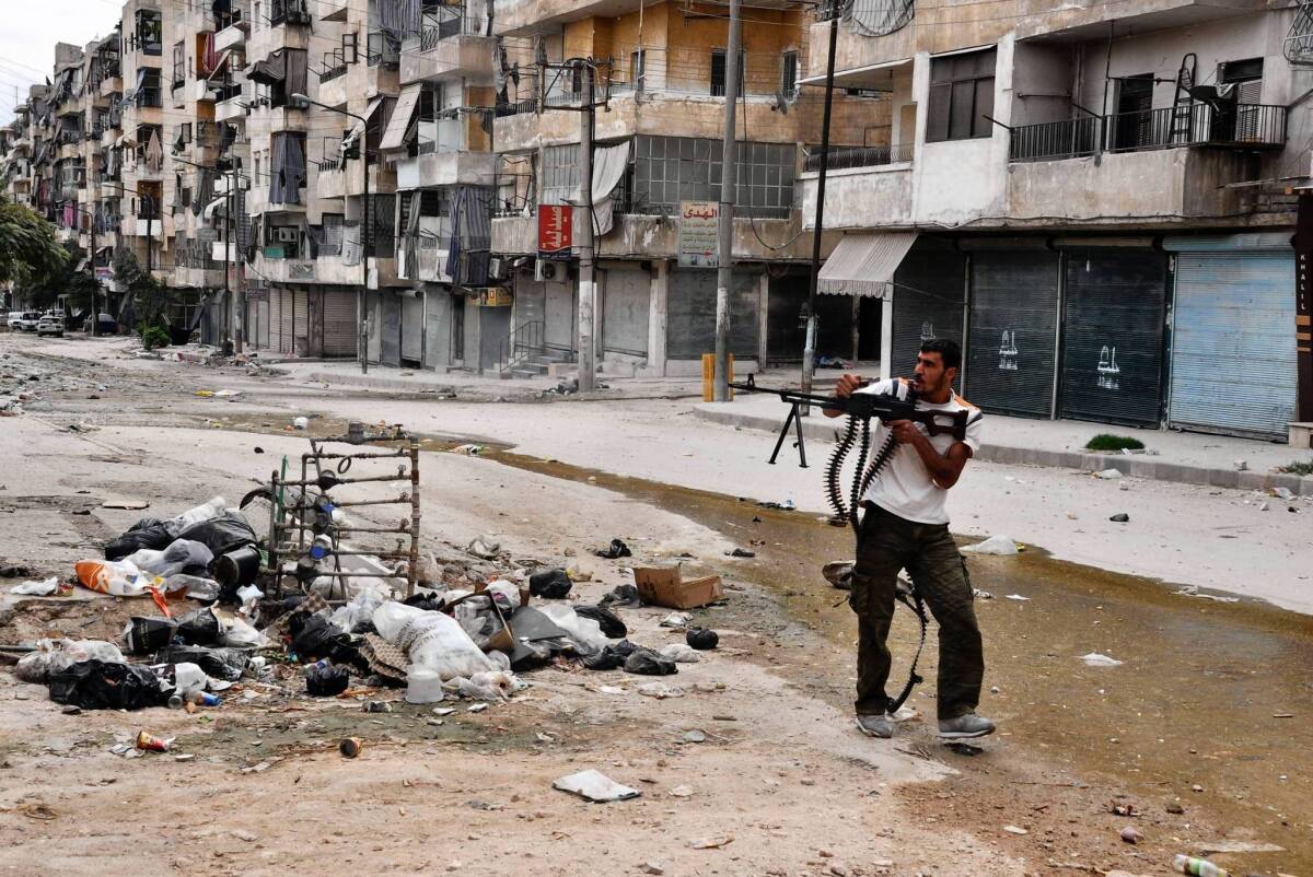 A Syrian rebel fires at pro-government forces in Aleppo.
