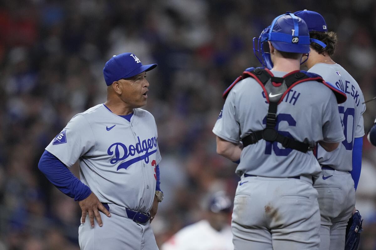 Dodgers manager Dave Roberts makes a pitching change during the sixth inning against the Astros Saturday in Houston. 