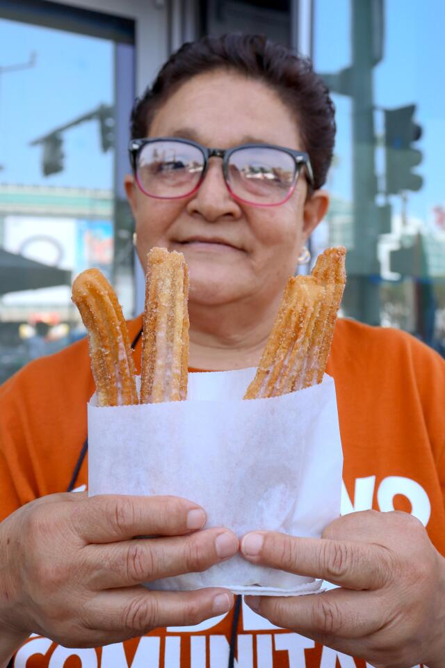 Street vendor Eva Orozco shows her lechera-drizzled churros