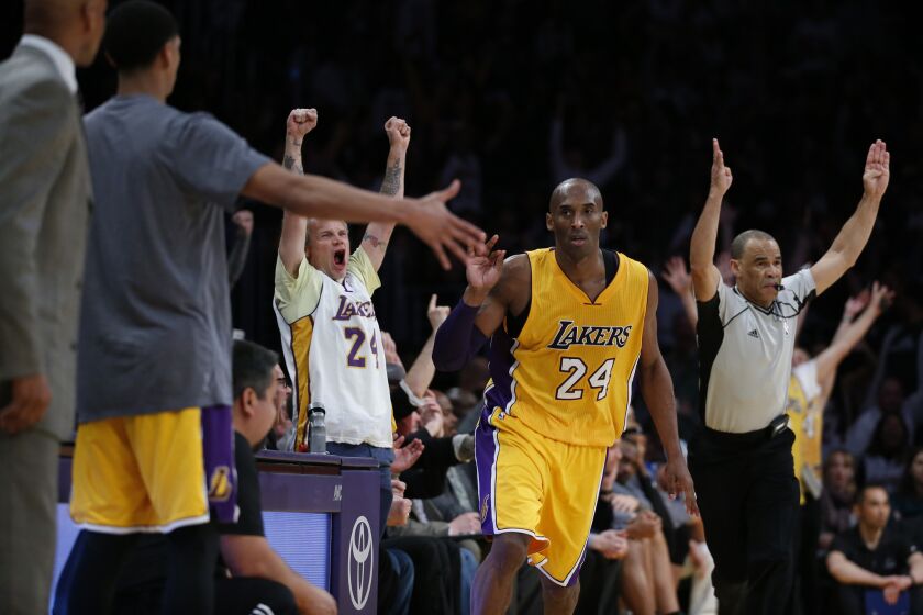 Lakers fans including Flea, celebrate after Kobe Bryant hits a three pointer late in the fourth quarter of a game against the Timberwolves on Feb. 2. at Staples Center.