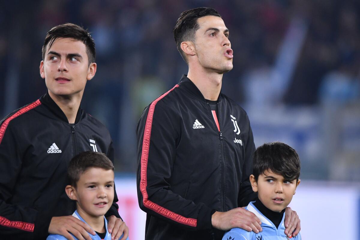 Juventus' Argentine forward Paulo Dybala (L) and Juventus' Portuguese forward Cristiano Ronaldo look on prior to the Italian Serie A football match lazio Rome vs Juventus Turin on December 7, 2019 at the Olympic stadium in Rome. (Photo by Alberto PIZZOLI / AFP) (Photo by ALBERTO PIZZOLI/AFP via Getty Images)