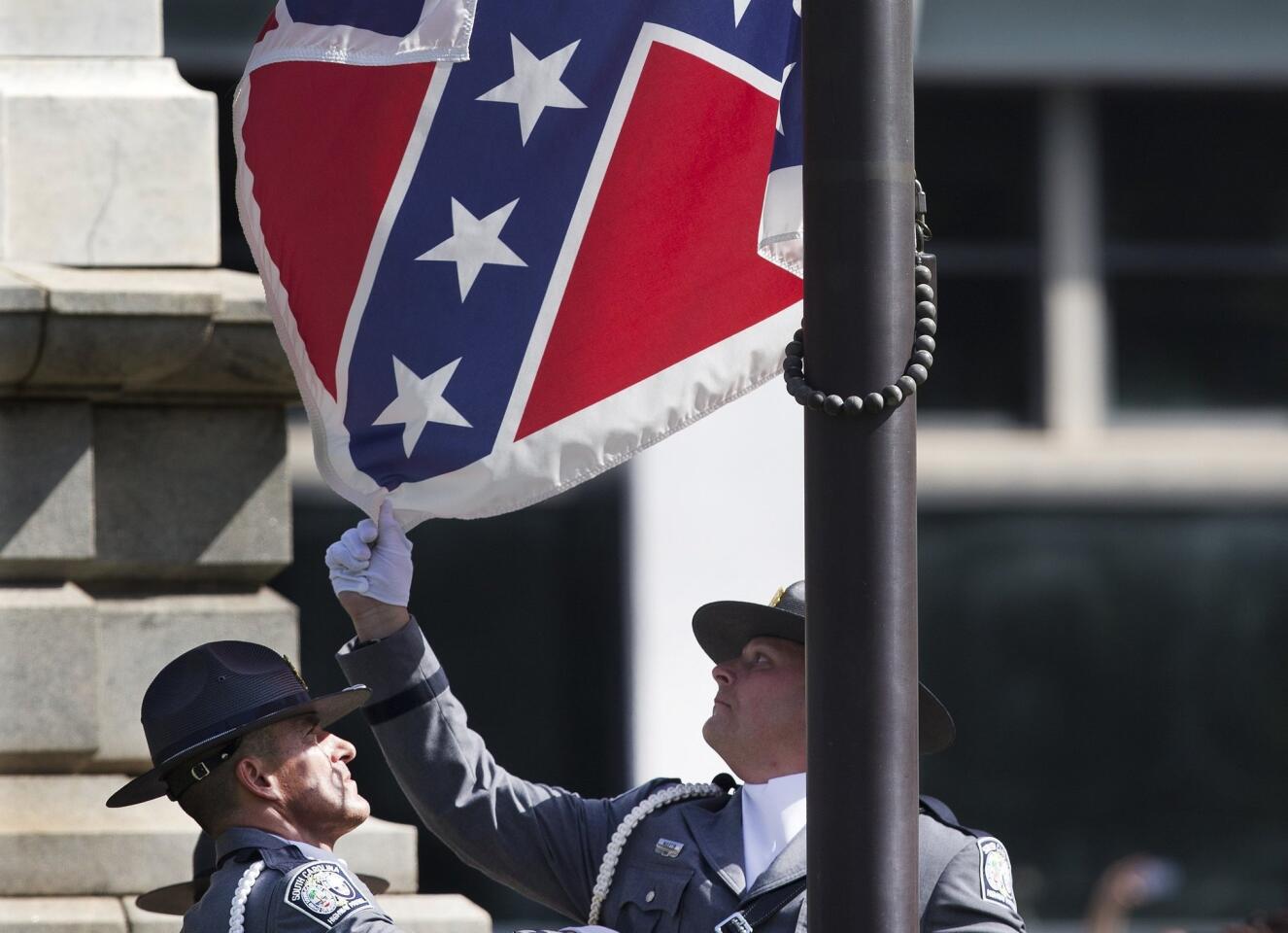 An honor guard from the South Carolina Highway patrol lowers the Confederate battle flag as it is removed from the Capitol grounds Friday.