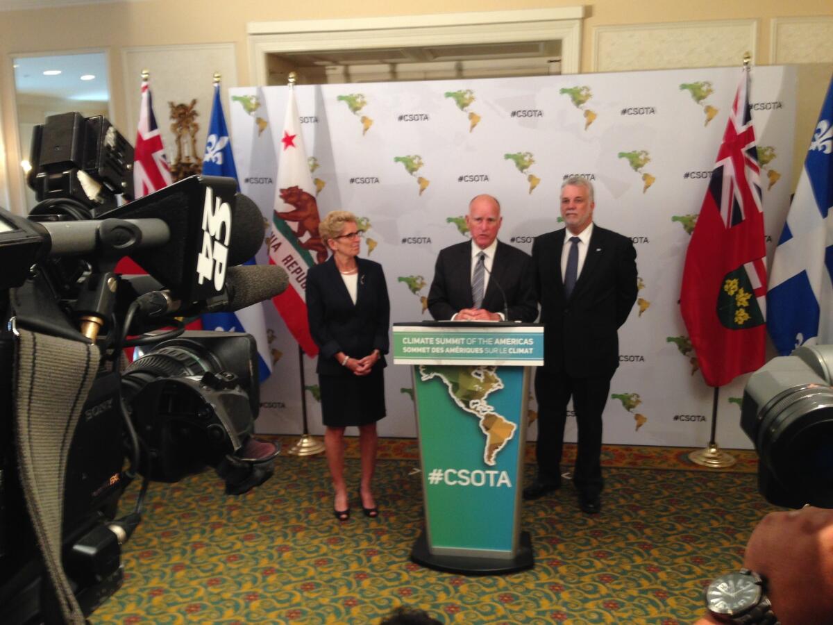 Gov. Jerry Brown, center, standing with Ontario Premier Kathleen Wynne and Quebec Premier Philippe Couillard, said he wanted to "light a fire" under national leaders to address climate change.