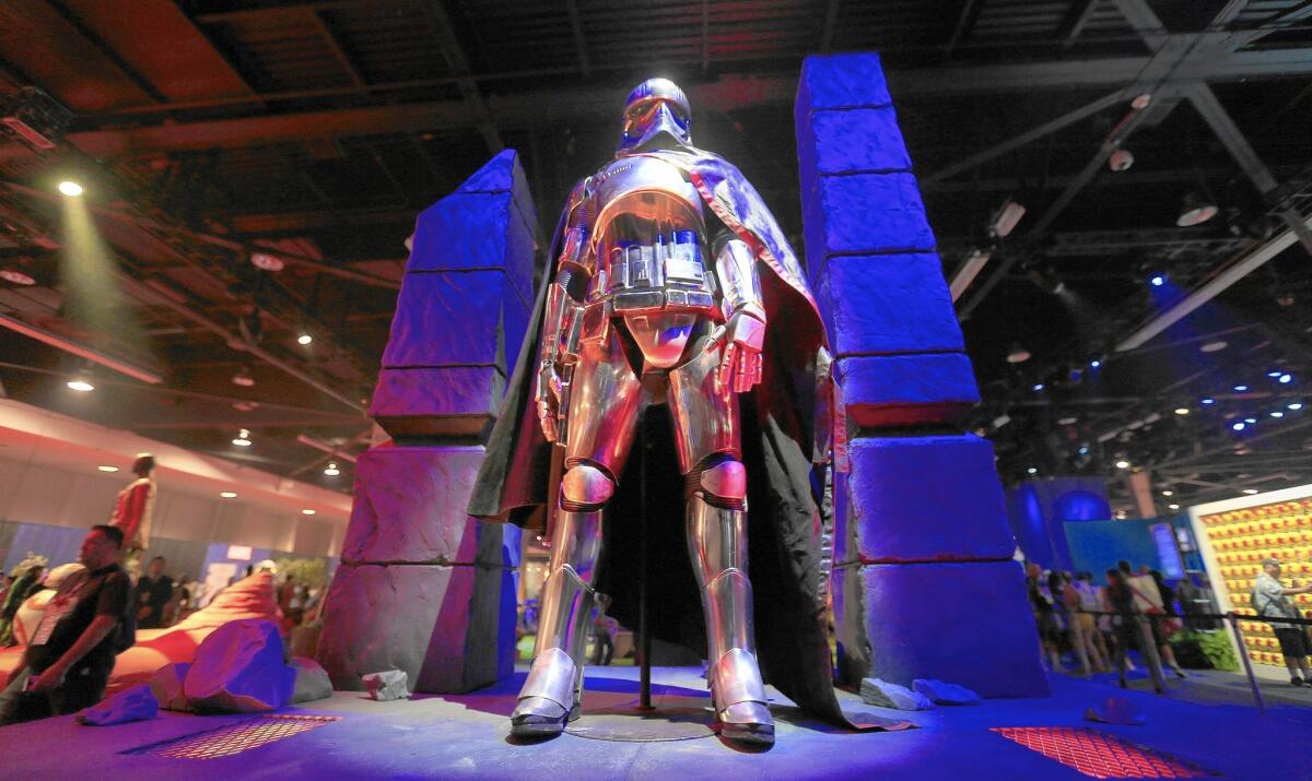 Captain Phasma from “Star Wars: The Force Awakens” is displayed at Disney's D23 convention in Anaheim in August. The excitement over the upcoming film helped boost sales of classic Star Wars toys in Disney’s consumer products business, where sales increased 11% to $1.2 billion in the latest quarter.