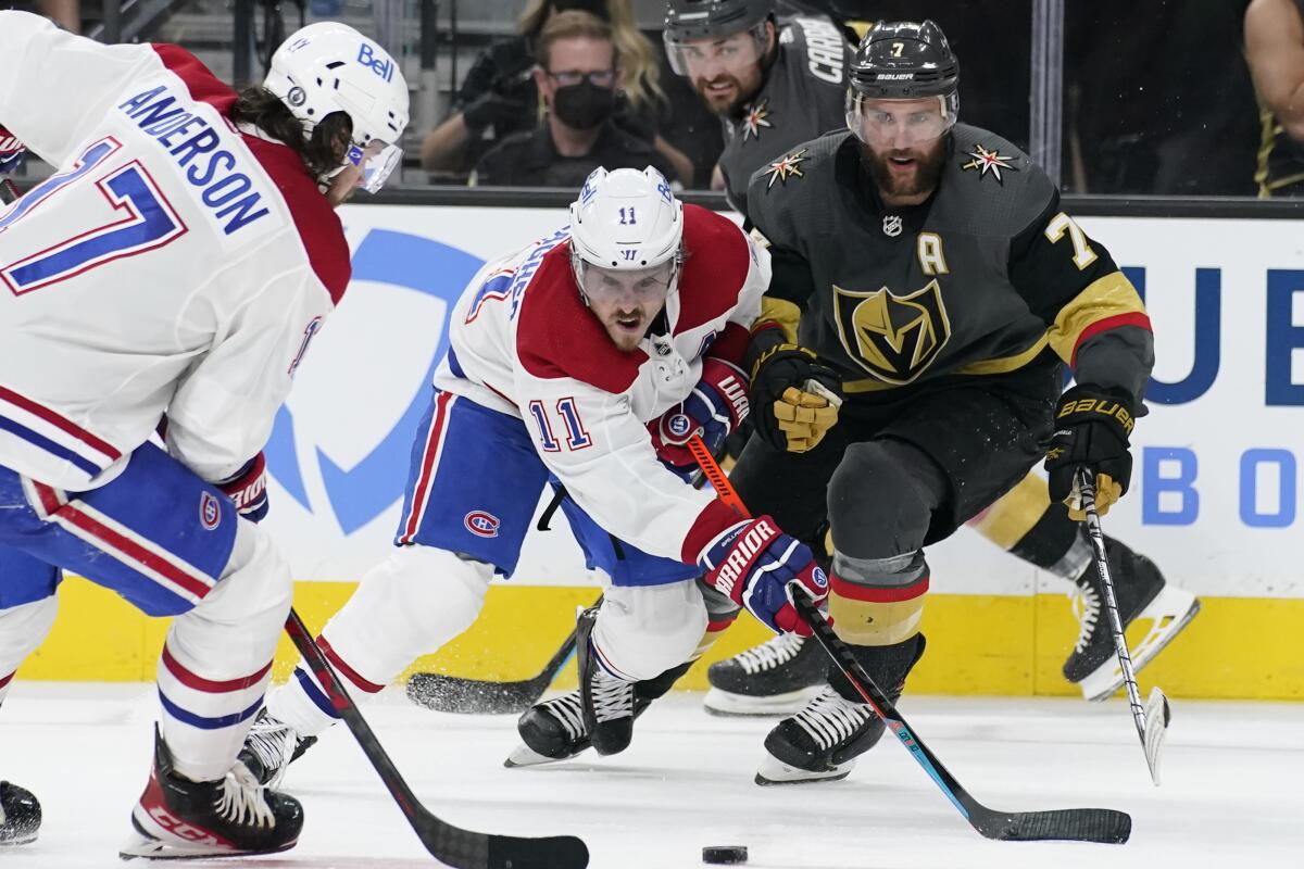 Montreal Canadiens right wing Brendan Gallagher (11) vies for the puck with Vegas Golden Knights defenseman Alex Pietrangelo (7) during the third period in Game 1 of an NHL hockey Stanley Cup semifinal playoff series Monday, June 14, 2021, in Las Vegas. (AP Photo/John Locher)