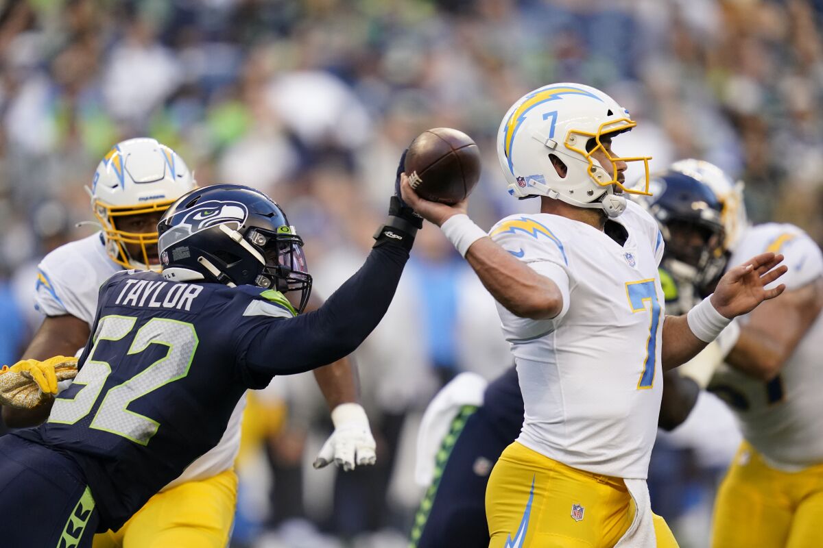 Seahawks defensive end Darrell Taylor reaches for the ball as Chargers quarterback Chase Daniel passes Aug. 28, 2021.