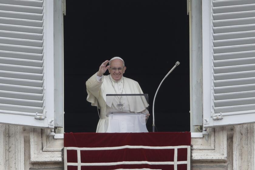 Pope Francis blesses the crowd as he recites the Angelus noon prayer from the window of his studio overlooking St.Peter's Square, at the Vatican, Sunday, Oct. 7, 2018. (AP Photo/Alessandra Tarantino)