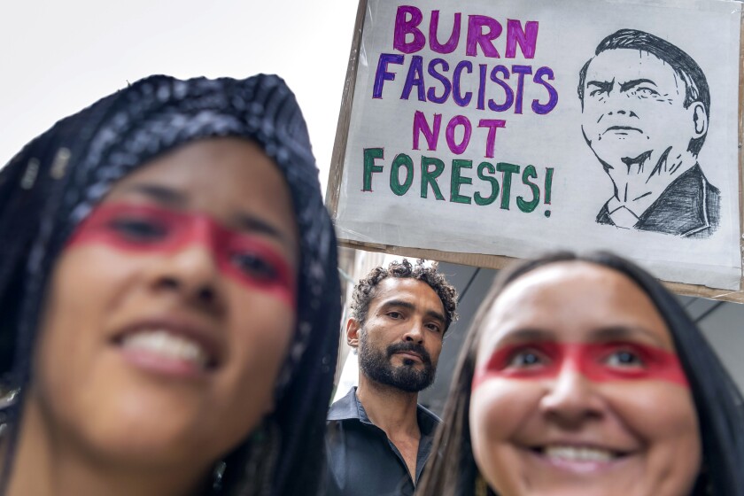 People protest in front of the Brazilian Consulate in Switzerland in 2019.