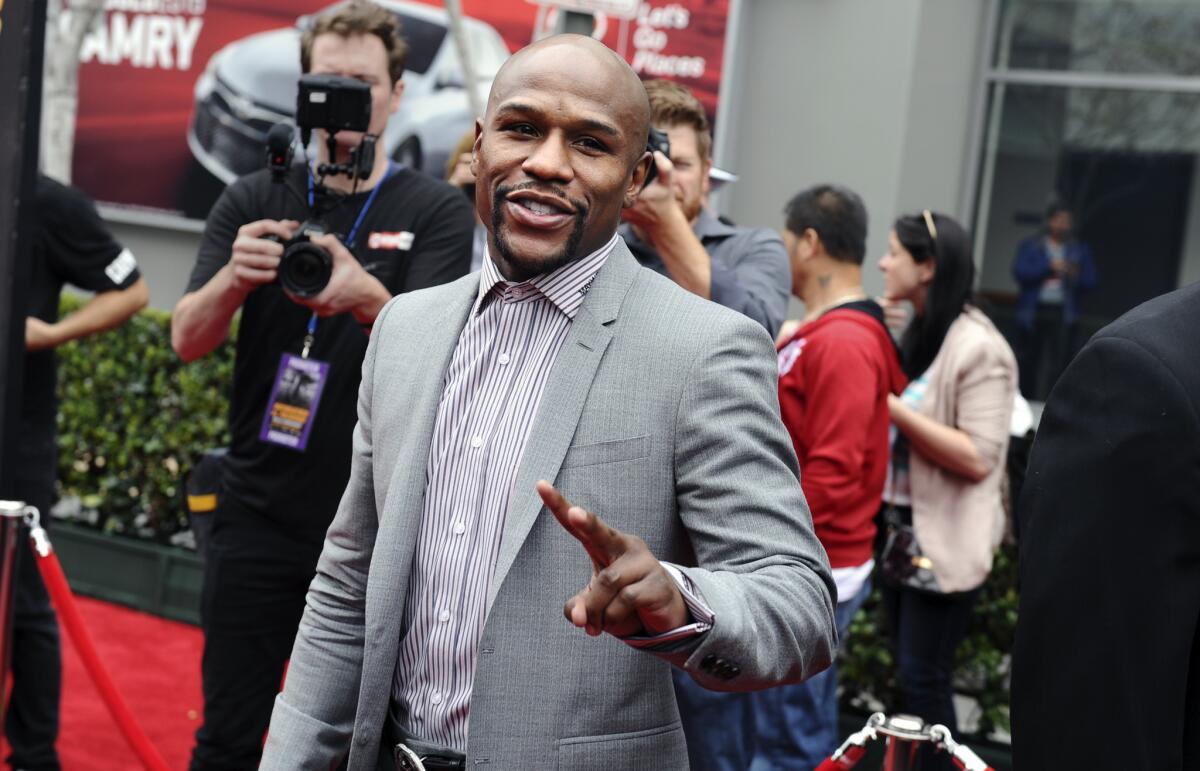 Boxer Floyd Mayweather Jr. walks the red carpet before a news conference at the Nokia Center earlier this month.