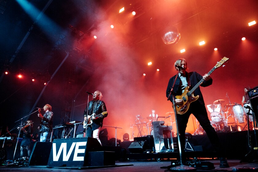 A rock band performs onstage