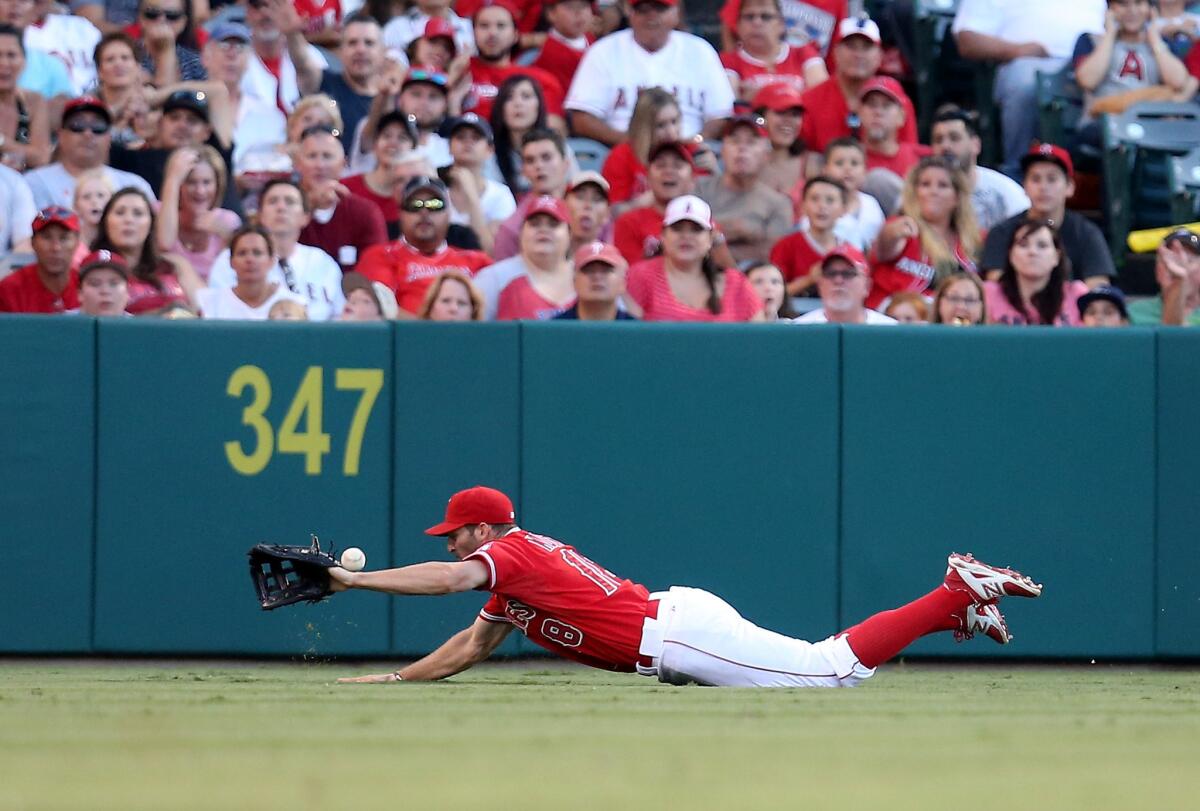 Former Angels left fielder Kyle Kubitza dives for a fly ball against the Rangers in Anaheim on July 25, 2015.
