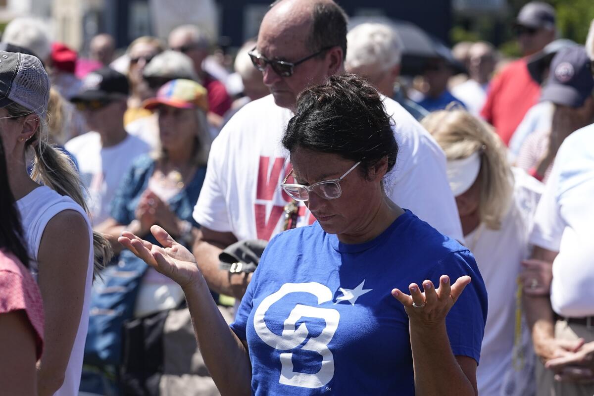 People praying during a rally in Ohio