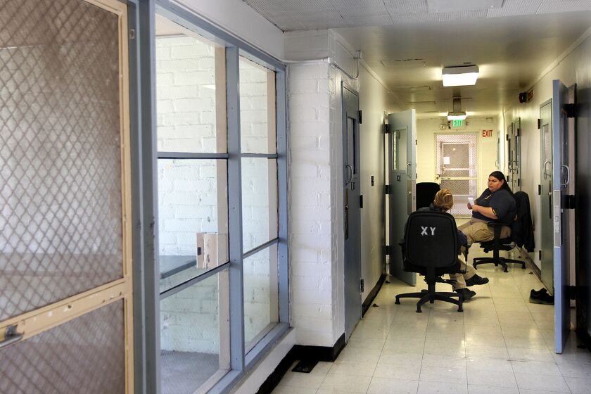 LOS ANGELES-CA-JULY 23, 2014: Detention services officers sit in a hallway watching over minors in the special handling unit at Central Juvenile Hall in Los Angeles on Wednesday, July 23, 2014. (Christina House / For The Times)