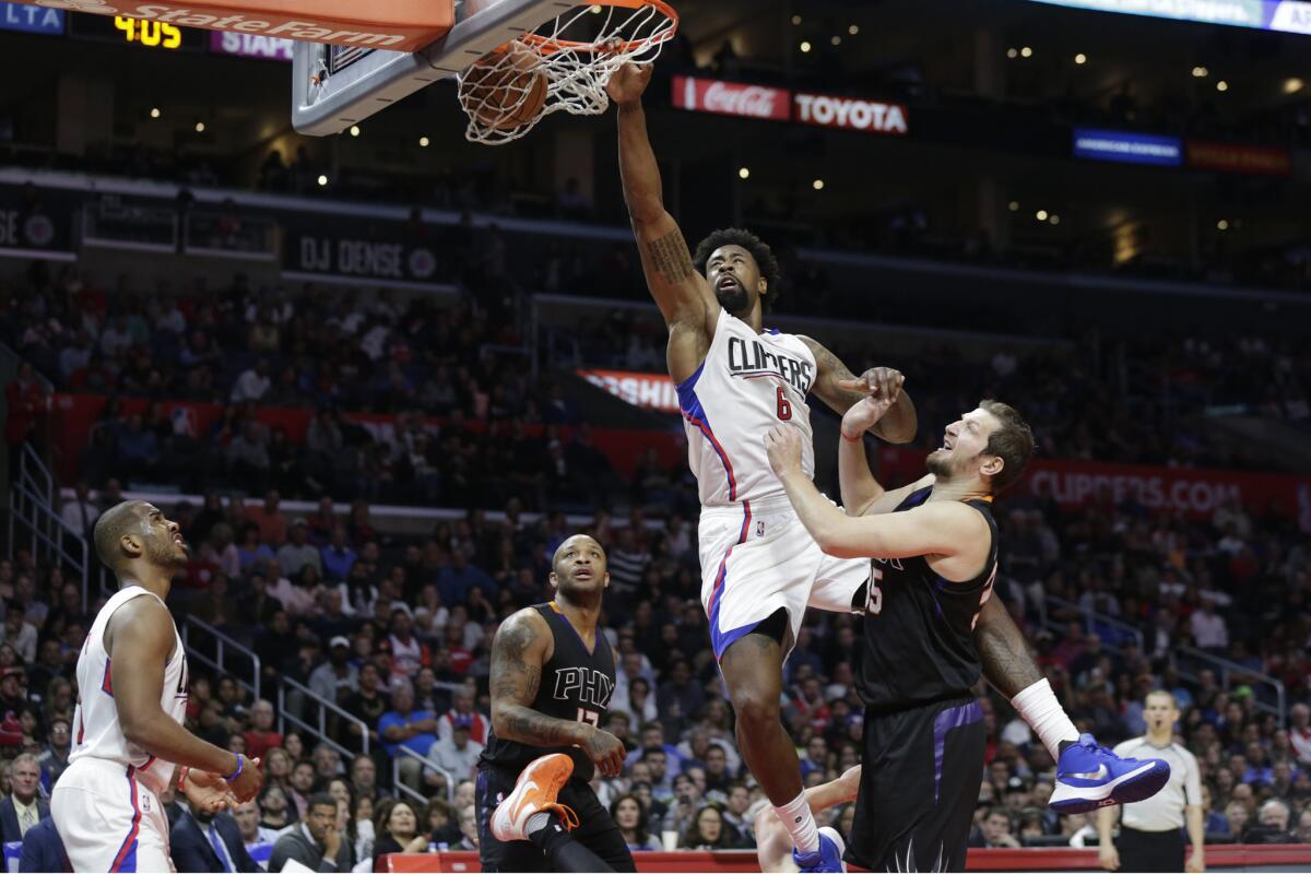 Clippers center DeAndre Jordan slams home two points over Suns forward Mirza Teletovic during third quarter action.