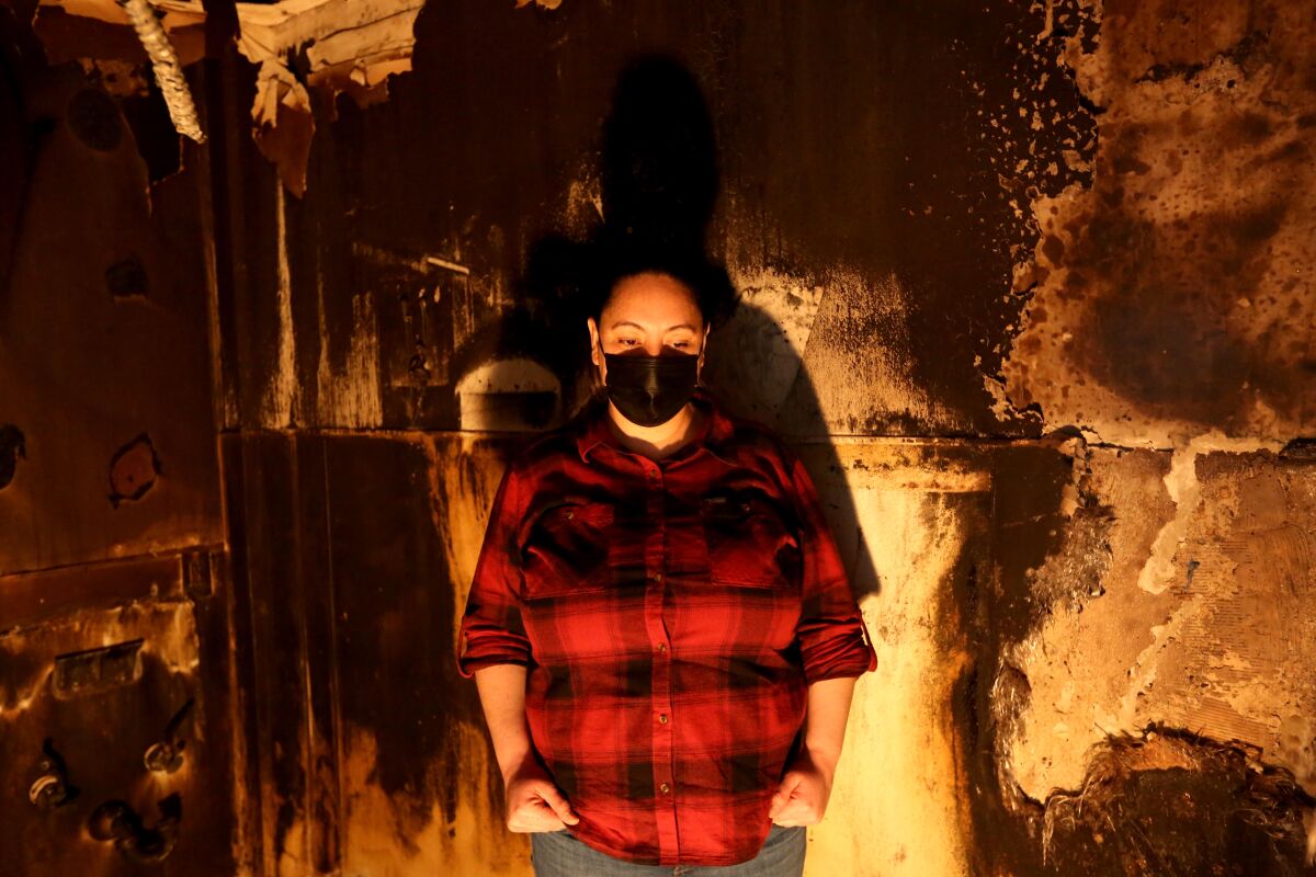 Stephanie Ramirez standing inside her fire damaged bakery, Spigas, in Orange.