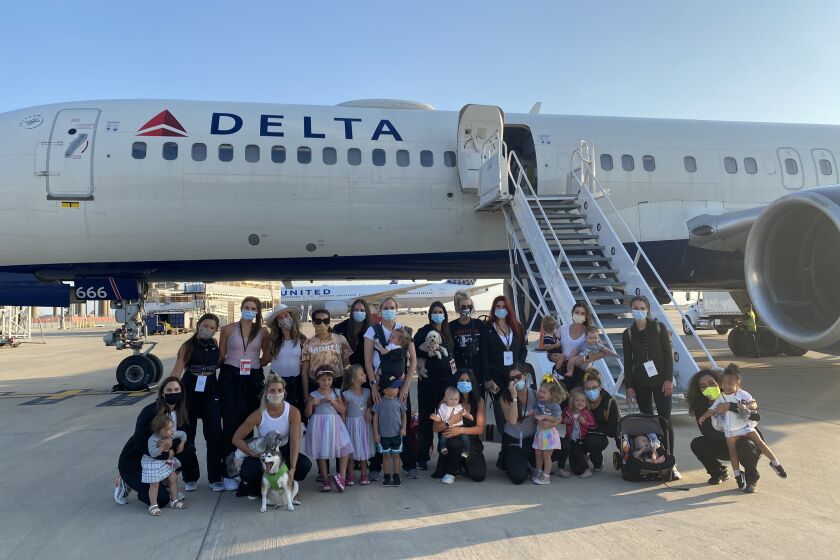Padres wives, girlfriends and children pose in front of their plane after landing in Texas to be part of the postseason bubble.