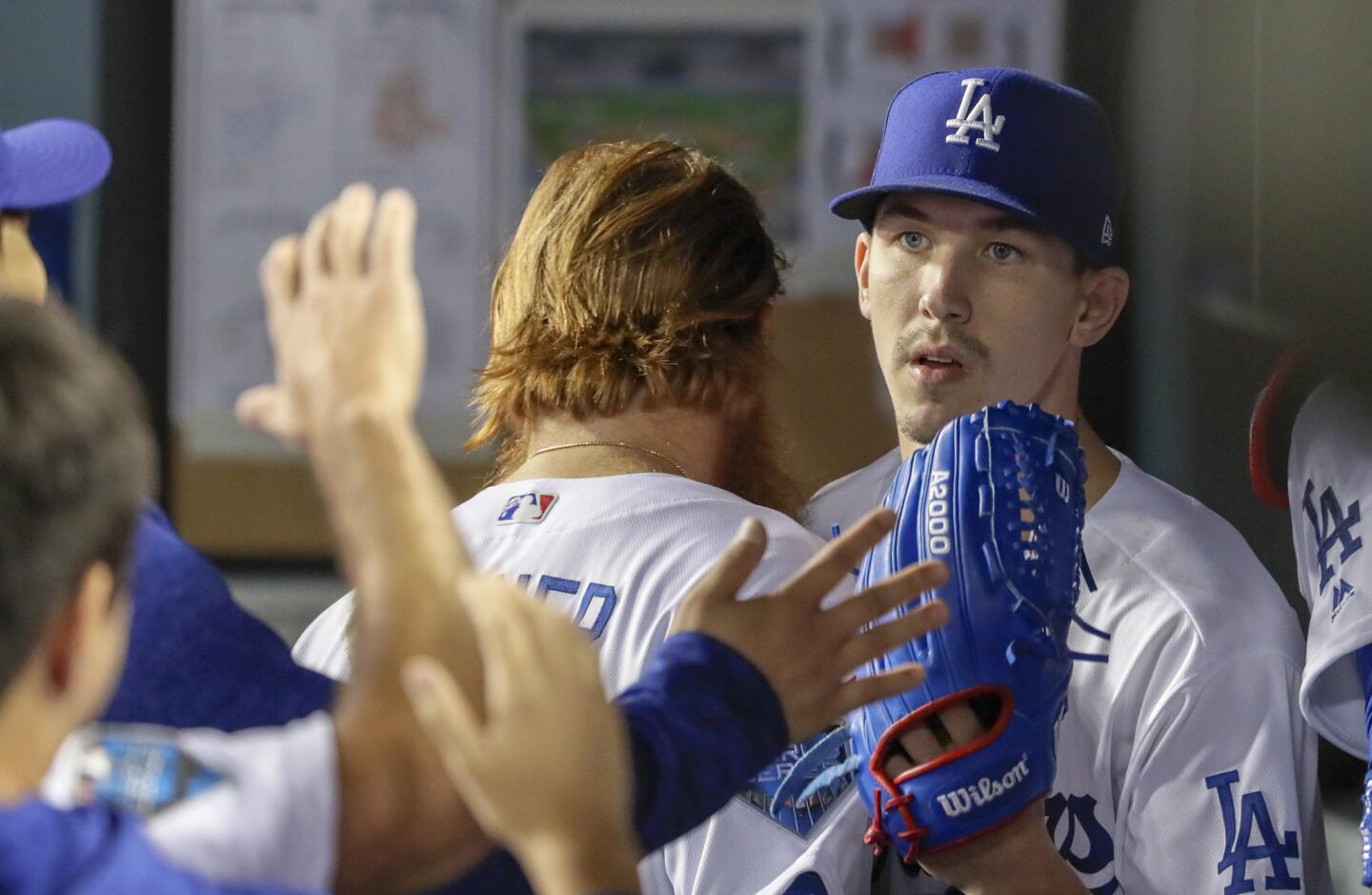 Dodger starting pitcher Walker Buehler is congratulated after the fifth inning.