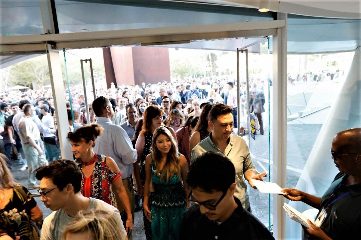 A crowd of guests wait to enter the newly opened Orange County Museum of Art on opening day.